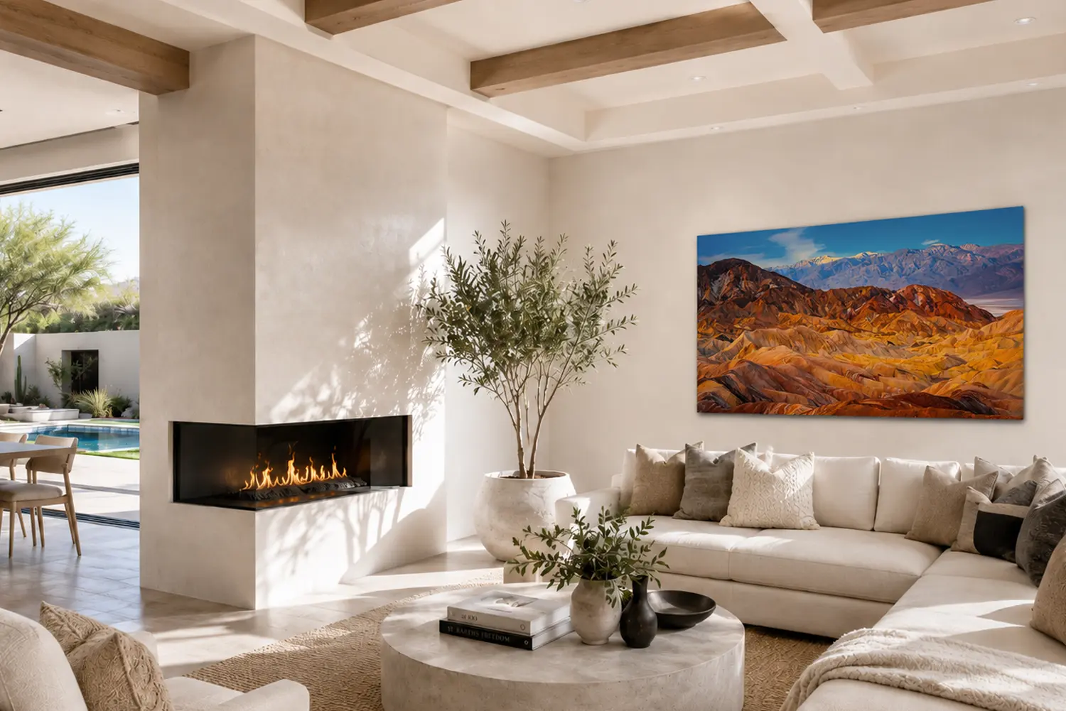 Painted Earth — Zabriskie Point Death Valley fine art print in a Southwest desert luxury residence great room with plaster walls, olive tree, and pool deck view.
