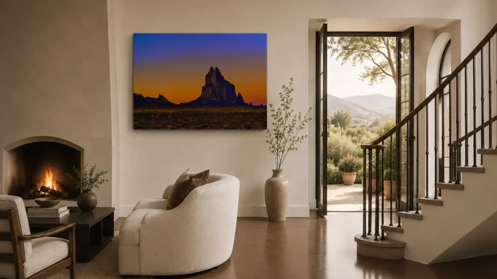 Sacred Twilight — Shiprock New Mexico fine art print in a Mediterranean-Southwest luxury residence with arched fireplace, curved staircase, olive trees, and Tuscan hills view