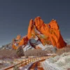 Snow-dusted red sandstone monoliths of Garden of the Gods rise against a deep blue winter sky, Colorado Springs, Colorado. Fine art landscape photograph with alpine winter conditions. Signature Series.
