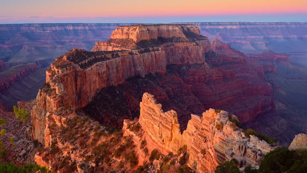 Wotan's Throne butte formation at sunrise, lit in warm rose and gold, Grand Canyon North Rim, Arizona. Fujifilm GFX medium format fine art photograph