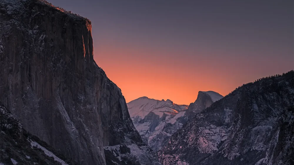 El Capitan and Half Dome in winter dawn alpenglow, snow on the valley floor, viewed from Tunnel View. Yosemite National Park, California. Nikon D810